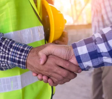 Construction worker team hands shaking greeting start up plan new project contract office center site partnership 185119297 360x320